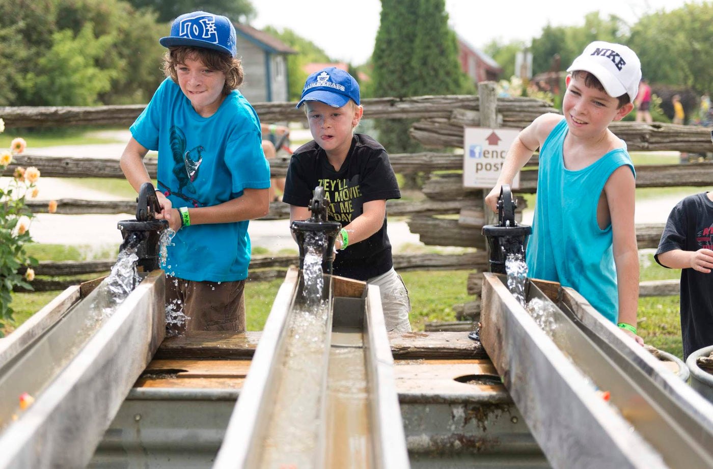 Children washing gems at the sluice on a summer afternoon