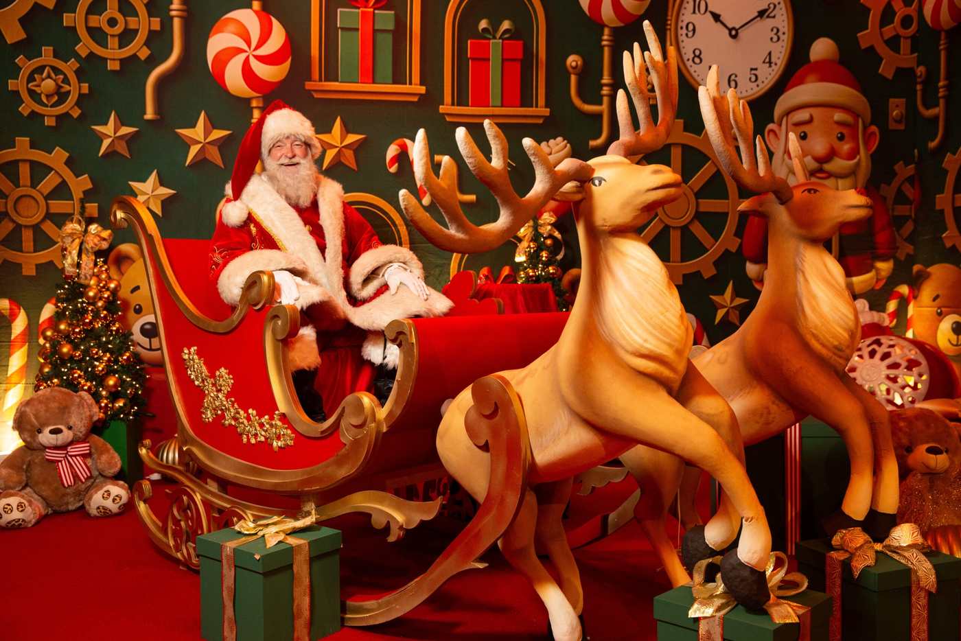 Santa in his sleigh with the reindeer at an indoor Christmas experience